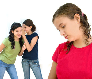 two young girls laughing behind another girls back